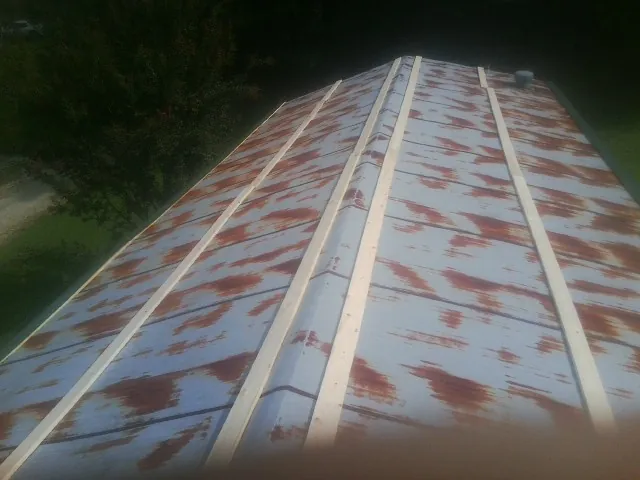 Rusted metal roof panels with new wood purlins before replacement — Storm Damage Roof Repair in Bally by Roofing Brothers